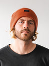 Discover warmth and style with our trendy rust beanie, a perfect accessory to add a pop of color and flair to your winter outfits.